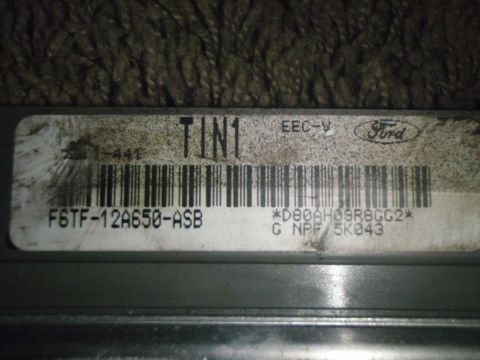 1996 Ford Bronco - Close-up of a Ford EEC-V engine control module, showing its part number and barcode.