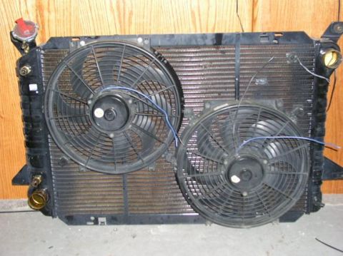 1996 Ford Bronco - Radiator assembly with dual electric fans and visible wiring, likely for an engine cooling system.