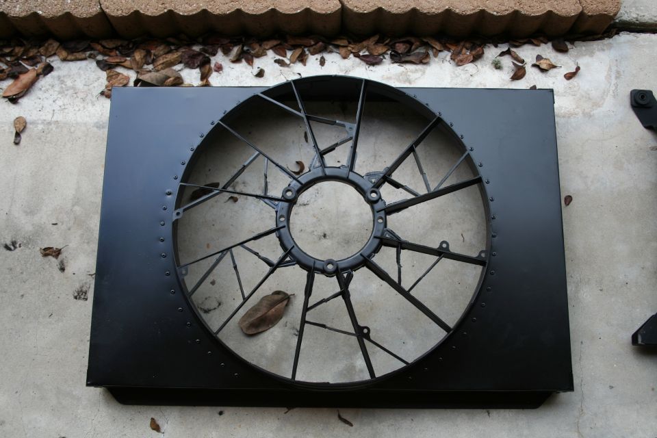 Black radiator fan shroud with a large circular fan assembly