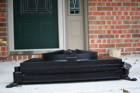 1996 Ford Bronco - A black radiator fan shroud with its fan is shown in front of a house entrance.