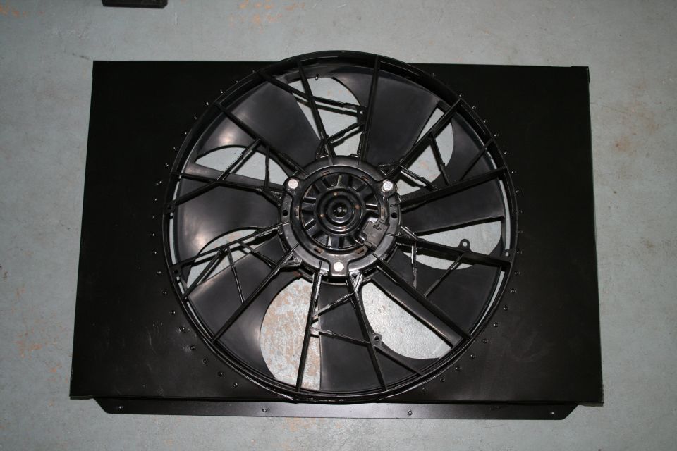 Black radiator fan shroud with a black fan, viewed from the front