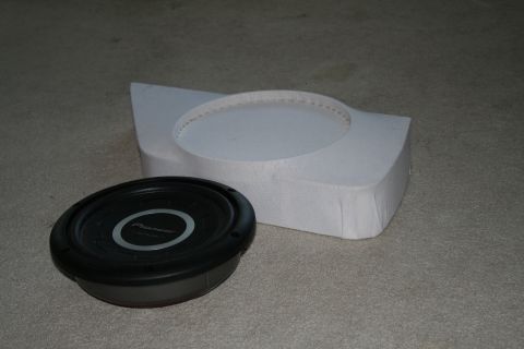 1996 Ford Bronco - A car subwoofer and its custom enclosure are shown on a carpeted surface.