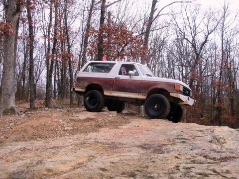 1989 Ford Bronco - This two-tone brown and white 1989 Ford Bronco navigates a challenging rocky trail.