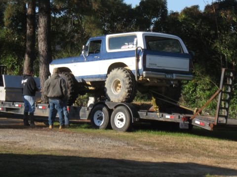 1994 Ford Bronco - Modified Ford Bronco being transported on a flatbed trailer.