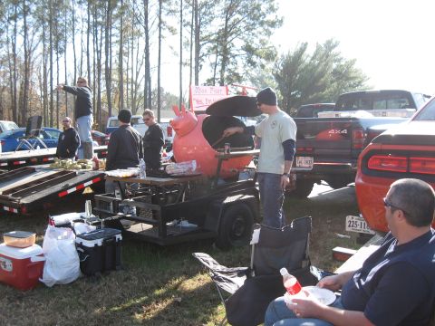 1994 Ford Bronco - Outdoor gathering with a unique pig-shaped grill and multiple vehicles present.