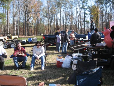 1994 Ford Bronco - An outdoor gathering takes place with several vehicles and people enjoying the day.