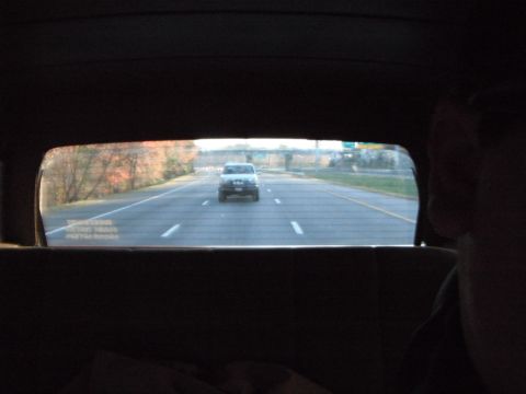 1989 Ford Bronco - A white 1989 Ford Bronco is seen driving on a highway, captured from inside another vehicle.
