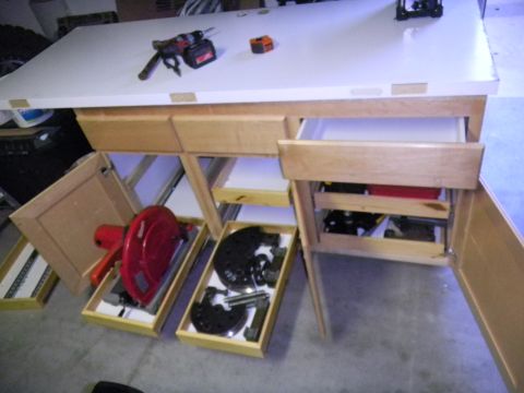 1997 Ford Ranger - Workbench setup with tools and automotive parts, including brake rotors and a blower.