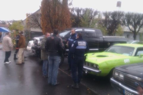 1991 Ford LTD Crown Victoria - A lime green muscle car is parked next to a black pickup truck, with several people standing around.