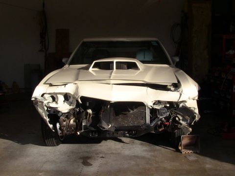 1972 Ford Ranchero - This car has significant front-end damage and appears to be undergoing repairs in a garage.