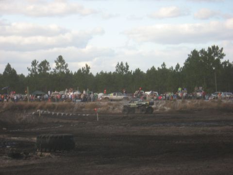 1994 Ford Bronco - A crowd watches as vehicles participate in a mud bogging event.