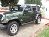 1995 Ford Bronco - This green Jeep Wrangler is shown from a three-quarter front view.