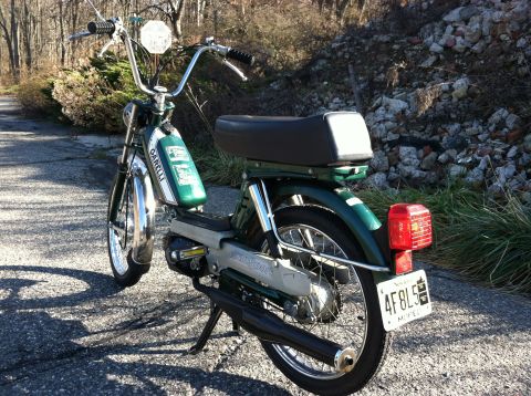1981 Garelli Rally Sport - Garelli moped parked on a paved surface with trees and rocks in the background.