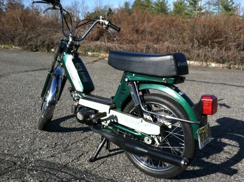 1981 Garelli Rally Sport - A green moped with chrome accents and a black seat is shown from a three-quarter front view.