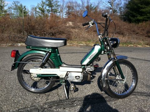 1981 Garelli Rally Sport - A green Garelli moped is parked on an asphalt surface with trees in the background.