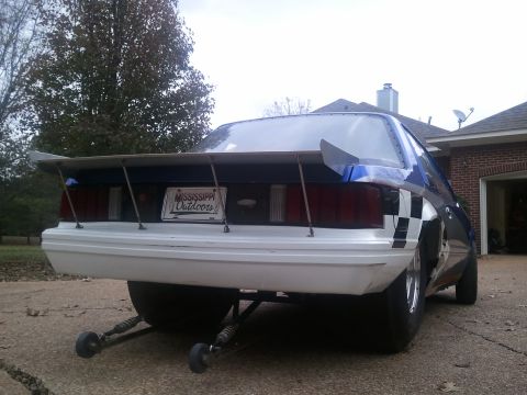 1967 Ford Mustang - This drag car features a large rear spoiler and a checkerboard design on its quarter panel.
