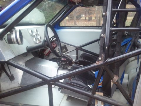 1967 Ford Mustang - The interior of a custom drag car features a roll cage, racing seats, and multiple gauges on the dashboard.