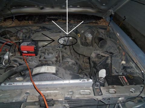 2000 Mercury Grand Marquis - The engine bay of a 1998 Ford Crown Victoria, with a battery charger connected to the engine.