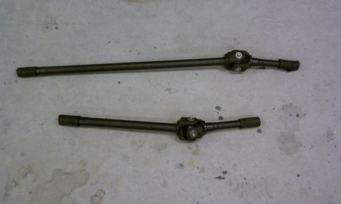 1979 Ford Bronco - Two driveshafts are shown on a concrete surface, with a SuperMotors.net watermark in the lower right corner.