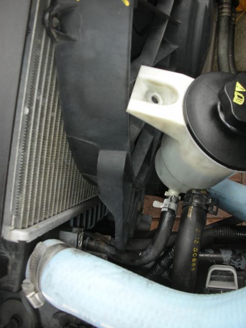 2004 Ford Crown Victoria - Radiator fan and coolant reservoir assembly with various hoses connected.
