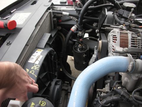 2004 Ford Crown Victoria - Close-up view of a vehicle's engine bay, focusing on the radiator and fan assembly.