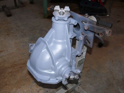 1976 Chevrolet Corvette - A differential housing, painted gray, is mounted on a stand in a workshop setting.