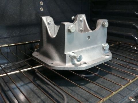 1976 Chevrolet Corvette - A metal car part is placed inside an oven on the rack.