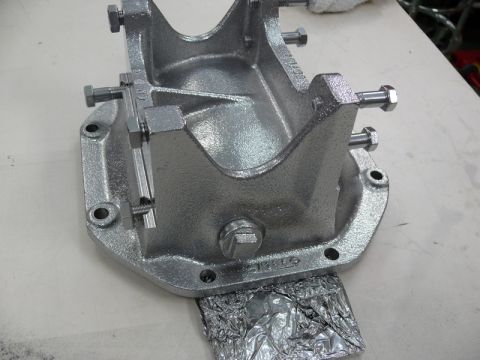 1976 Chevrolet Corvette - A silver metal differential cover is shown, resting on crumpled foil.