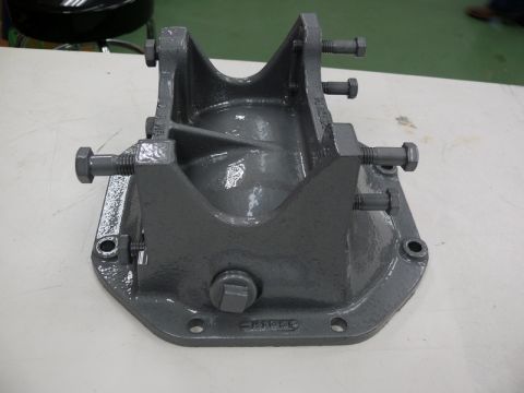 1976 Chevrolet Corvette - This is a gray metal differential housing part with bolts. The part has some text cast into it.