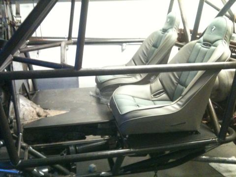 1966 Ford Bronco - Interior view of a custom off-road buggy, two bucket seats and a prominent roll cage.
