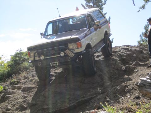 1991 Ford Bronco - This 1991 Ford Bronco tackles a challenging off-road trail on a sunny day.