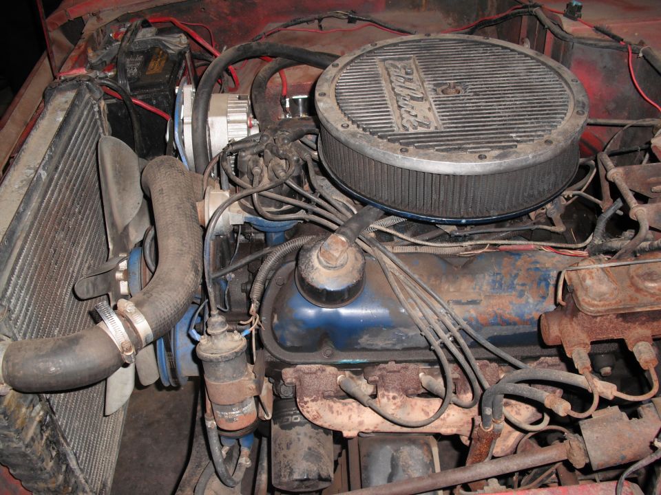 Engine bay with blue valve covers and a round air filter