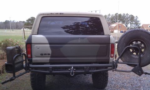 1979 Ford Bronco - This 1979 Ford Bronco features a camouflage paint scheme and a rear-mounted spare tire with an auxiliary fuel can carrier.