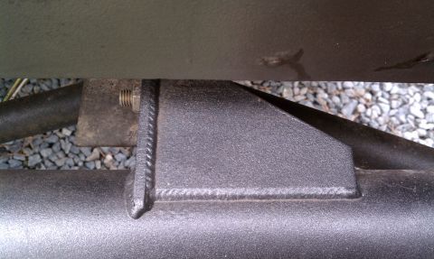 1979 Ford Bronco - Close-up of a welded metal bracket on a vehicle's frame rail.