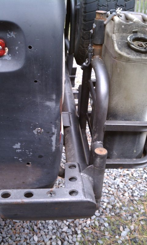 1979 Ford Bronco - This vehicle's rear features a spare tire carrier and a jerry can mounted to custom tubing.
