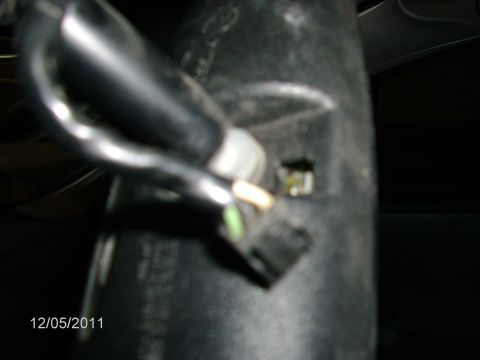 1979 Ford F-150 - A close-up view of a wiring harness and connector, showing exposed wires and a small green component.