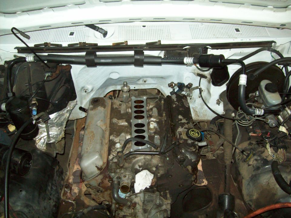 Engine bay of a 1993 Ford F-150, showing the V8 engine with intake manifold removed