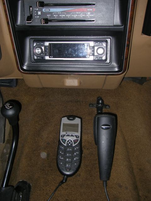 1990 Ford Bronco - The interior of a 1990 Ford Bronco shows a tan dashboard with an aftermarket radio and climate controls.