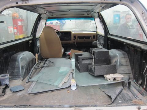 1987 Dodge 1500 - The interior of a 1987 Dodge 1500 pickup truck shows disassembled parts and seats, suggesting a restoration or repair project.
