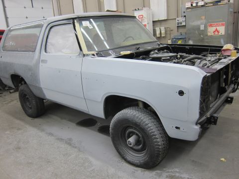 1987 Dodge 1500 - This SUV, likely from the 1980s, is in a workshop with its hood up and bodywork prepped for paint.