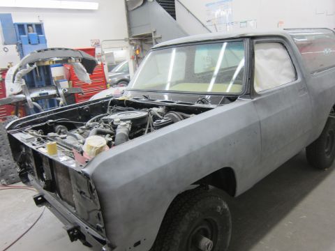 1987 Dodge 1500 - This pickup truck, likely from the 1980s, is in a workshop undergoing bodywork and preparation for painting.
