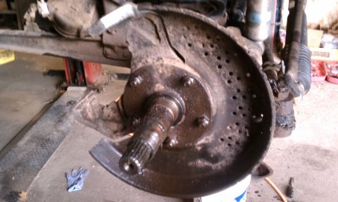 1979 Ford Bronco - Close-up of a vehicle's brake rotor and hub assembly, showing wear and tear.