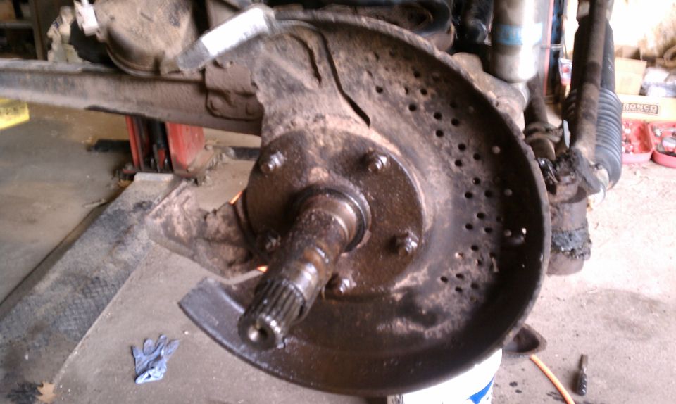Vehicle brake rotor and hub assembly, dirty and worn, with perforated disc
