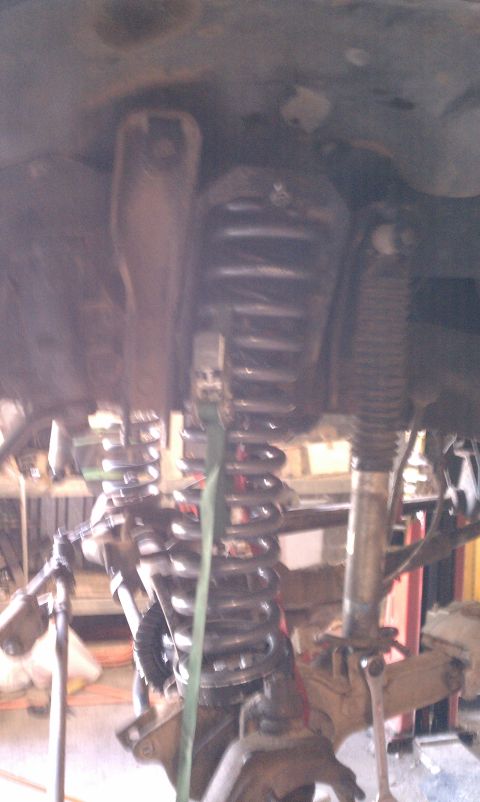 1979 Ford Bronco - Close-up view of a vehicle's front suspension system, showing springs and shock absorbers.