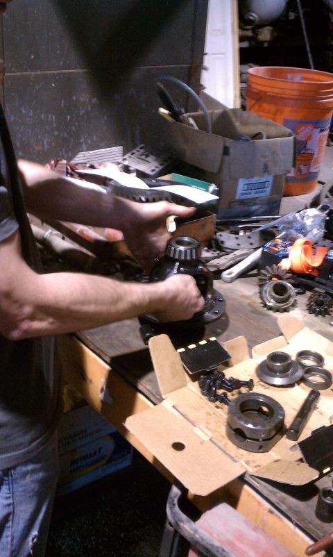 1979 Ford Bronco - Differential carrier and components laid out on a workbench for assembly or repair.