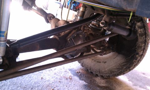 1979 Ford Bronco - Undercarriage view showing the rear axle and suspension system of a vehicle.