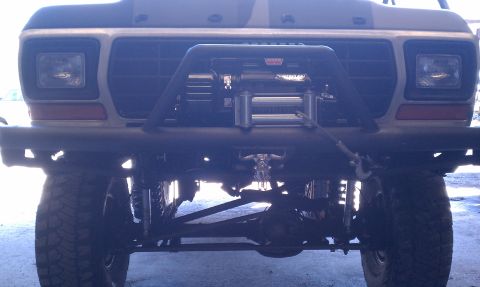 1979 Ford Bronco - Front view of a 1979 Ford Bronco, modified with a heavy-duty bumper and winch, a bull skull ornament.