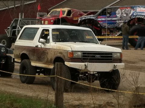 1989 Ford Bronco - This 1989 Ford Bronco is parked with other vehicles at an outdoor event.