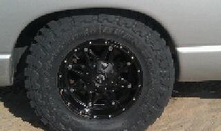 2005 Dodge 1500 - Close-up of a custom wheel and tire assembly on a truck.