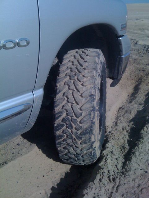 2005 Dodge 1500 - A 2005 Dodge 1500's aggressive off-road tire is shown on a sandy surface.